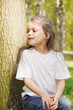 Girl sitting at tree