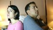 A couple who have been arguing sit silently.
