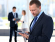 Businessman using electronic tablet in office
