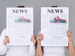 Foto: Two girls reading newspaper Two girls reading newspaper