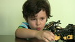 Boy plays with his  toy motorbike