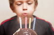 Smiling child with birthday cake candle