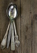vintage silver cutlery on a wooden background
