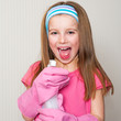 little girl cleans the house