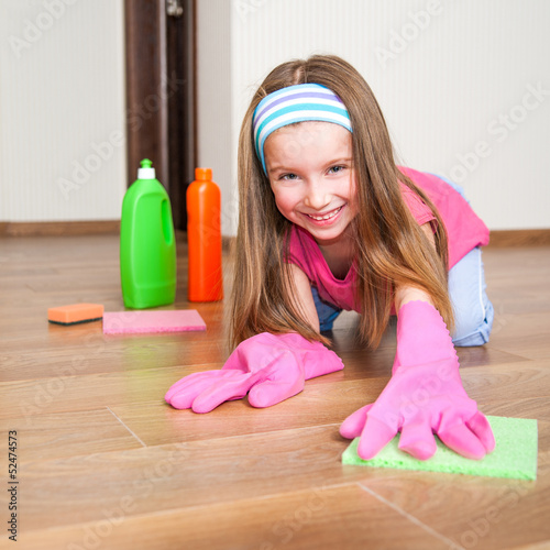 Photo: little girl cleans the house little girl cleans the house