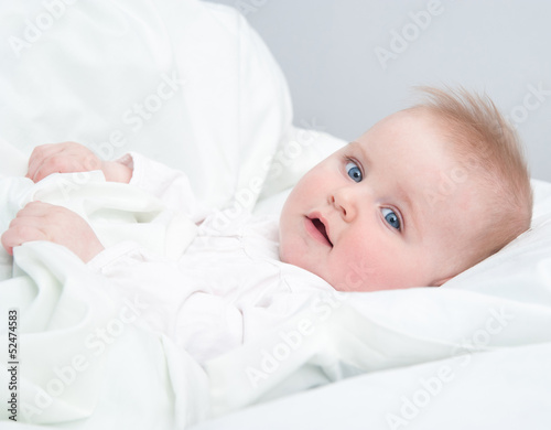 Photo: baby lying in the bed baby lying in the bed