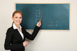 Portrait of teacher woman near chalkboard in classroom