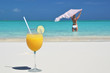 Glass of orange juice on the sandy beach of Exuma, Bahamas