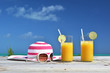 Sunglasses, hat and orange juice