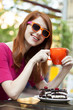 Photo: Style redhead girl with cup and cake Style redhead girl with cup and cake