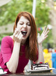 Style redhead girl with cup and cake