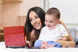 mother and son are using laptop