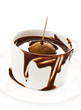 Cup of hot chocolate cocoa flow on white background, close up