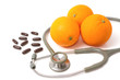 Pill and stethoscope with orange fruit ,Vitamin C supplement and