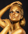 Reflexion. Woman with Bright Golden Makeup. Bronze Bodypaint