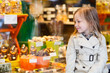 Little girl looking at chocolate in shop