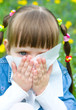 girl is blowing her nose