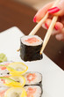 Photo: sushi with chopsticks sushi with chopsticks