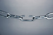 Broken chain on gray background