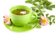 Cup of herbal tea with hip rose flowers, isolated on white