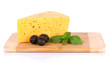 Photo: Cheese,basil and black olives on cutting board isolated on Cheese,basil and black olives on cutting board isolated on