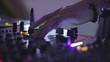 Hands of female Dj tweak turntable and mixer in the nightclub