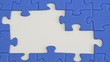 building a jigsaw of blue pieces with hand