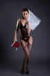 Sexy bride posing in black lingerie and veil