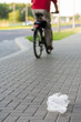 Plastic bag thrown by biker  on the street, littering the city.
