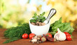 Composition of mortar, spices, tomatoes and  green herbs,