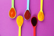 Baby puree in spoons on purple background