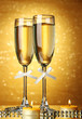 Photo: Two glasses of champagne on bright background with lights Two glasses of champagne on bright background with lights
