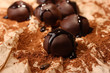 Chocolate candies with cocoa powder, close up