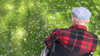 Old man in wheelchair enjoying spring in the park