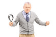 Angry mature man holding a belt and looking at camera