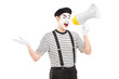 Male mime artist speaking at loudspeaker and looking at camera
