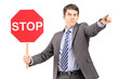 Man in suit holding a stop sign