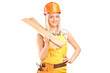 Smiling female carpenter with helmet holding sills