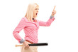 Violent young woman holding a baseball bat and threatening