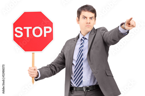 Photo: Man in suit holding a stop sign Man in suit holding a stop sign