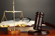 Wooden gavel, golden scales of justice  and books