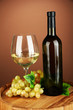 Composition of wine bottle, glass of white wine, grape