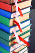 Many books with bookmarks on gray background