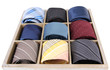 Neckties in wooden box isolated on white