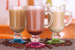 Photo: Layered coffee in glass on table on bright background Layered coffee in glass on table on bright background