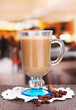 Layered coffee in glass on table on bright background