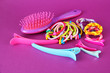 Scrunchies, hairbrush  and  hair - clip   on a pink background