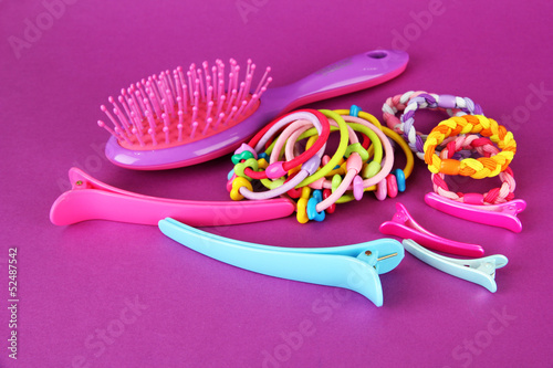Photo: Scrunchies, hairbrush and hair - clip on a pink background Scrunchies, hairbrush and hair - clip on a pink background