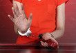 Prisoner in handcuffs behind glass in soundproof room