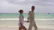 Happy young couple walking on the beach